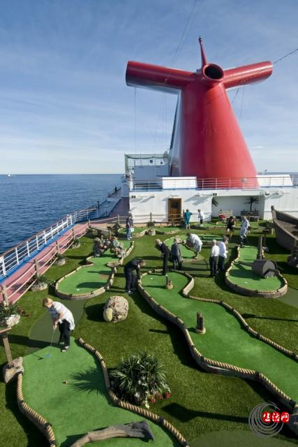 Golfers hone their putting skills on an 18-hole miniature golf course aboard the 130,000-ton Carnival Dream. FOR EDITORIAL USE ONLY (Photo by Andy Newman/Carnival Cruise Lines/HO