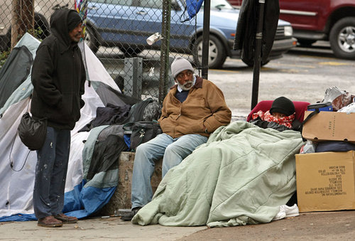 120711 Atlanta, Ga; Homeless people get bundled up as they dress for the cold weather at the corner of Peachtree Street and Pine Street across the street from the Metro Atlanta Task Force for the Homeless Wednesday afternoon in Atlanta, Ga., December 7, 2011. Even though the shelter has a reputation for not turning people away there are still some who sleep near by. Some of the criticism about the shelter is that they don't do anything about the homeless that are constantly seen around the shelter. We spend a day in the life of the homeless shelter at Peachtree and Pine. Jason Getz jgetz@ajc.com
