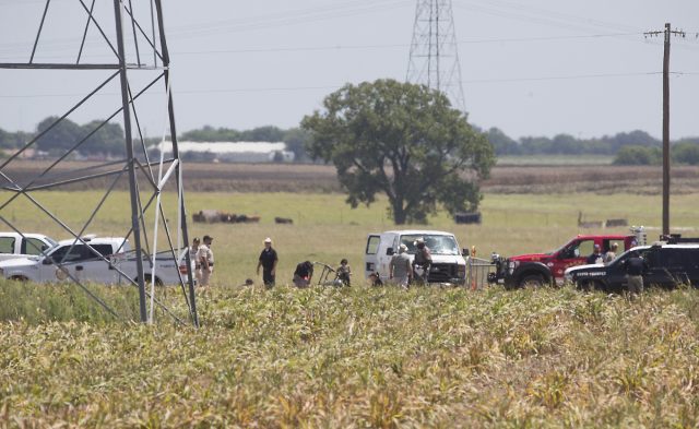 The partial frame of a hot air balloon is visible above a crop field in Maxwell, TX as investigators comb the wreckage of a Saturday morning accident that left 16 people dead when the balloon crashed. Teams of law enforcement agencies including Caldwell County Sheriffs office, Texas Department of Public Safety and the National Transportation Safety Board are combing the scene of a hot air balloon accident that killed 16 people riding Saturday morning July 30, 2016 in an open field near Maxwell, TX. RALPH BARRERA/AMERICAN-STATESMAN
