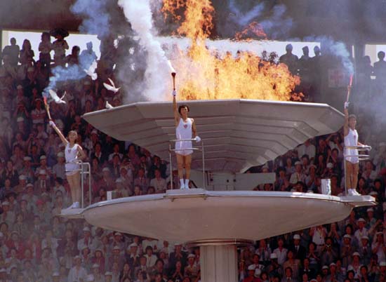 Doves fly around as the Olympic torch is lit during opening ceremonies in Seoul Sept.17, 1988. (AP Photo/Stf)