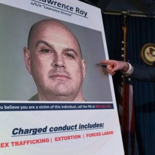 Manhattan US Attorney Geoffrey Berman points at a photo of Lawrence Ray as charges are announced in New York City in February 2020.
